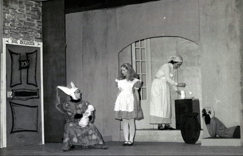 Select this image to see a larger version. The Duchess' Kitchen.
L to R:  The Duchess (Jacquie Russell), Alice (Margaret Tweedy), The Cook (Mary
Govas), The Cheshire Cat (Susan Drane).
Photo supplied by Jacquie Russell
