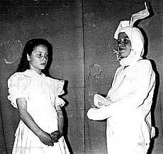 Select this image to see a larger version. Linda Bradley (Alice) with Neil Saunders (White Rabbit).
