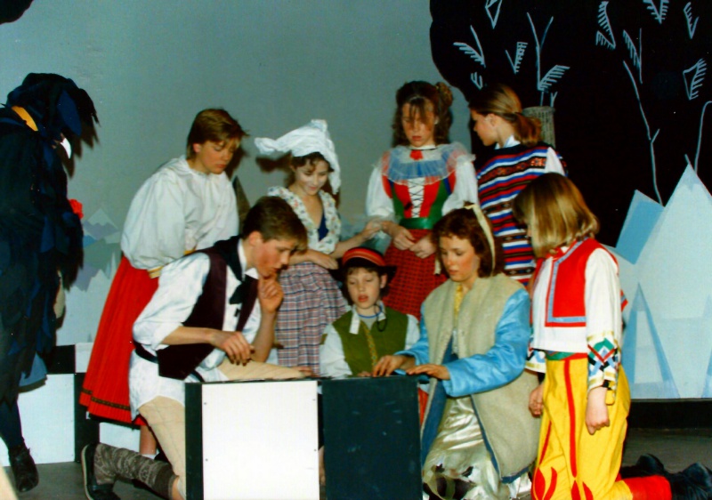 Select this image to see a larger version. Kai (Jeremy Murrell) and Gerda (Claire Garnett) with the other prisoners of the Snow Queen (believed to be:- Anna Fairgrieve; Amy Charles; Elisabeth Brownbill; Tanya Baker; Anharad Rees-Williams and (in front) Gareth Benest) try to work out the key word to rebuild the mirror, watched by Krark (Paul Bacon - left).