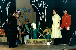 Urdr (Aviva Wiseman - left) with Gerda (Clare Garnet - second right) in the Enchanted Garden with (from right to left) Wooden Soldier (Graham Wilkinson), Tiger Lily (Angharad Rhys-Williams), Snowdrop (Tania Baker) and Gar the Garden Gnome (Matthew Humberstone). Select this image to see a larger version. 