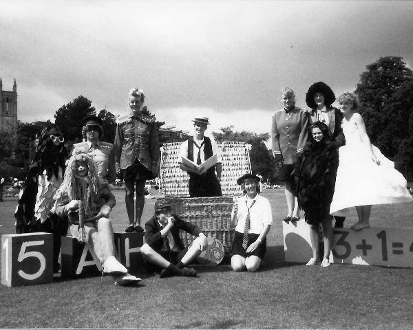Select this image to see a larger version. L to R
Paul Bacon (Raven)
Caroline Rumens (Lion),
Mike Jefferies (Soldier),
Sania Pell (Majorette),
Andrew Brimelow (seated, Schoolboy),
Pete Machin (standing in basket. Storyteller),
Clare Murrell (kneeling. Schoolgirl),
Hayley Brown (uniform. Majorette),
Anne-Marie Crawford ('feathers'),
Sarah Parsons? (Golly) &
Nicky Walsh (Doll)