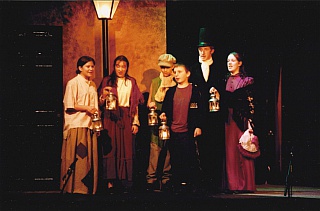 Bob (Chris Henry) with his wife (Liv Priest) and their children (L>R) Belinda (Chloe Mantripp), Martha (Holly Le Ber Smith), Tiny Tim (Michael Turner) and Peter (James Jeans) Select this image to see a larger version. 