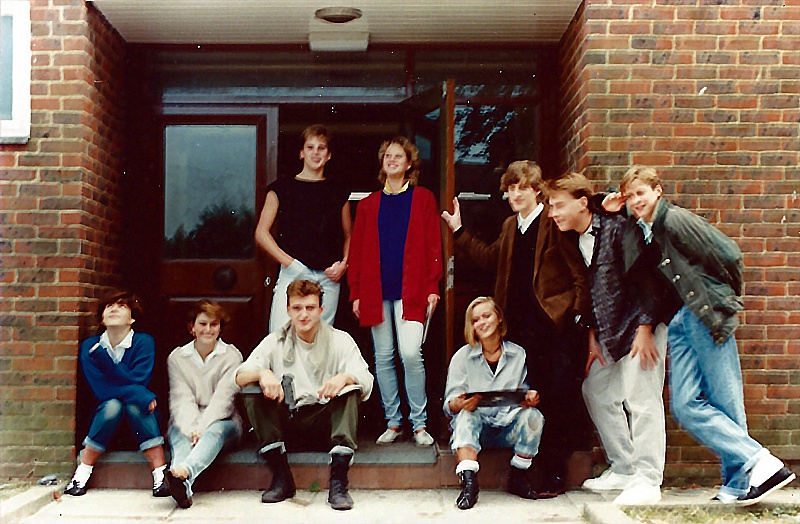 Select this image to see a larger version. A break from rehearsals outside Curzon Centre, 1986. L2R: ?, ?, Edward Thornton (seated), ?, Anne-Marie Crawford (red cardigan), Tania Schnadhorst, Royston Northridge (brown jacket), Matthew Humberstone, Jeremy Murrell.